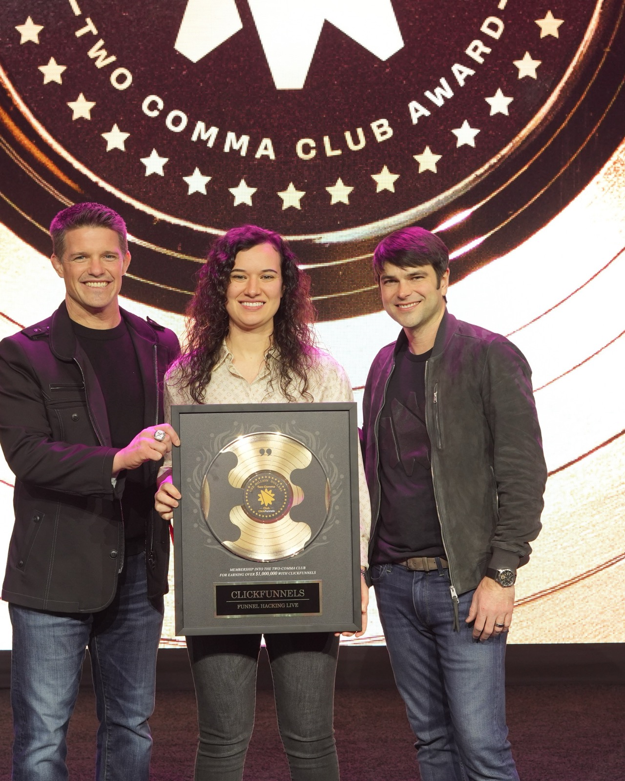 Hannah Ingram receiving the Two Comma Club award on stage
